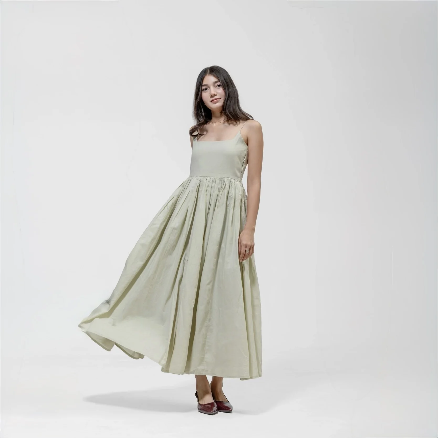 QISSEY PLEATED MAXI GOWN — LONG CAMISOLE DRESS WITH A DEEP GATHERED WAIST AND THIN SPAGHETTI STRAPS.